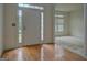 Bright entryway with hardwood floors and a white front door featuring sidelights and transom windows at 235 Rustic Mill Ln, Fayetteville, GA 30214