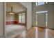 Spacious entryway with hardwood floors and a view into the adjacent room with wallpaper and carpet at 235 Rustic Mill Ln, Fayetteville, GA 30214