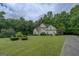 Two-story home set back from the road with a spacious front yard and mature trees at 235 Rustic Mill Ln, Fayetteville, GA 30214
