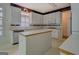 Functional kitchen with white cabinetry, a center island, and modern appliances at 235 Rustic Mill Ln, Fayetteville, GA 30214