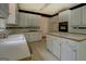 Well-equipped kitchen with white cabinets, stainless steel appliances, and ample counter space for cooking at 235 Rustic Mill Ln, Fayetteville, GA 30214