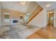 Bright living room with vaulted ceiling, fireplace, and staircase with wood railing at 235 Rustic Mill Ln, Fayetteville, GA 30214