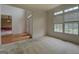 Living room featuring carpeted floors, a large window, and a view into the front entryway at 235 Rustic Mill Ln, Fayetteville, GA 30214