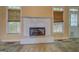 Living room with a fireplace, windows, and carpeted floors needing renovation at 235 Rustic Mill Ln, Fayetteville, GA 30214