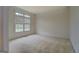 Living room featuring carpeted floors and large windows with blinds at 235 Rustic Mill Ln, Fayetteville, GA 30214