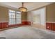 Living room featuring a large window, wallpaper with chair rail, and carpeted floors at 235 Rustic Mill Ln, Fayetteville, GA 30214