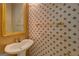 Charming powder room featuring patterned wallpaper, a pedestal sink, and a decorative mirror at 235 Rustic Mill Ln, Fayetteville, GA 30214