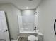 This bathroom includes a new toilet and a clean, bright shower-tub combo with modern black fixtures at 295 Lamden Ct, Lawrenceville, GA 30046