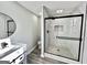 Modern bathroom with custom vanity and sleek glass enclosed shower at 295 Lamden Ct, Lawrenceville, GA 30046
