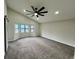 Spacious bedroom with a ceiling fan, a sliding door, carpet floors and natural light at 295 Lamden Ct, Lawrenceville, GA 30046