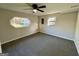 Bedroom featuring neutral walls, cozy carpet, a ceiling fan and eye-catching window at 295 Lamden Ct, Lawrenceville, GA 30046