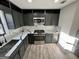 Modern kitchen with stainless steel appliances, gray cabinets and marble backsplash at 295 Lamden Ct, Lawrenceville, GA 30046