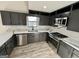 Beautiful kitchen with updated stainless steel appliances, gray cabinets, and counter tops at 295 Lamden Ct, Lawrenceville, GA 30046