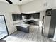 Modern kitchen featuring stainless steel appliances, marble countertop, and gray cabinetry at 295 Lamden Ct, Lawrenceville, GA 30046