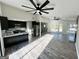 Great open concept living room featuring large ceiling fan and modern flooring at 295 Lamden Ct, Lawrenceville, GA 30046