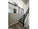 An interior staircase with decorative wrought iron railing leads to the main living area with modern ceiling fan and fireplace at 295 Lamden Ct, Lawrenceville, GA 30046