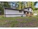 Home and backyard featuring mature trees and large green lawn at 770 Four Winds Ln, Jonesboro, GA 30238