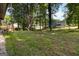 Home's backyard with grass, mature trees and a wooden deck at 770 Four Winds Ln, Jonesboro, GA 30238