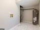 Unfinished basement space with new flooring, water heater and utility connections at 770 Four Winds Ln, Jonesboro, GA 30238
