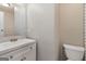 Bright bathroom featuring a white vanity with a large mirror and a toilet at 770 Four Winds Ln, Jonesboro, GA 30238