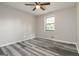 Bedroom with ceiling fan, window, and wood-look floors at 770 Four Winds Ln, Jonesboro, GA 30238