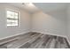 Neutral bedroom with wood-look floors, a large window and fresh gray paint at 770 Four Winds Ln, Jonesboro, GA 30238