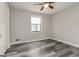 Bedroom features wood-look floors, ceiling fan and a window at 770 Four Winds Ln, Jonesboro, GA 30238
