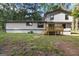 View of the home's rear exterior showing the deck and lawn at 770 Four Winds Ln, Jonesboro, GA 30238