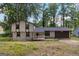 Two-story home featuring neutral siding, covered porch, attached garage, and surrounded by mature trees at 770 Four Winds Ln, Jonesboro, GA 30238
