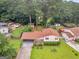 Aerial shot featuring a landscaped yard, mature trees, and a glimpse of nearby community amenities at 8310 Meridian Dr, Riverdale, GA 30274