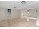 Open basement area with tile flooring, showcasing access to unfinished space, laundry and other rooms at 8310 Meridian Dr, Riverdale, GA 30274