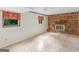 Spacious basement area with a brick fireplace and unique tile flooring offers a cozy, inviting atmosphere at 8310 Meridian Dr, Riverdale, GA 30274