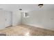 Basement room with neutral walls, tiled floors, and a door to the exterior for easy access at 8310 Meridian Dr, Riverdale, GA 30274