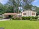 Charming single-Gathering home featuring a carport, mature trees, and a well-maintained front yard at 8310 Meridian Dr, Riverdale, GA 30274