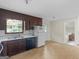 Kitchen features wood cabinetry, white appliances, and tile flooring at 8310 Meridian Dr, Riverdale, GA 30274