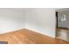 Neutral living room with wood floors, white walls and access to kitchen at 8310 Meridian Dr, Riverdale, GA 30274