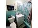 Well-lit turquoise bathroom featuring blue tiled walls, sink, and toilet at 500 Circle Dr, Fayetteville, GA 30214
