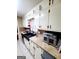 Galley kitchen with updated countertops, tile backsplash, and a black farmhouse sink at 500 Circle Dr, Fayetteville, GA 30214