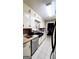 Well-equipped kitchen with white cabinetry, tile backsplash, and stainless steel dishwasher at 500 Circle Dr, Fayetteville, GA 30214