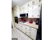 Kitchen featuring white cabinetry, neutral countertops, and essential appliances at 500 Circle Dr, Fayetteville, GA 30214