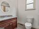 Bathroom features granite countertop, cherry vanity, and ceramic tiled floors at 187 Vanira Se Ave, Atlanta, GA 30315