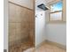 Bathroom with tiled shower, a built-in bench, and a window at 187 Vanira Se Ave, Atlanta, GA 30315