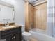 Bathroom featuring granite vanity, toilet, and a shower-tub combo with decorative tile at 187 Vanira Se Ave, Atlanta, GA 30315