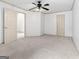 Spacious bedroom with neutral carpet, a ceiling fan and access to an en-suite bathroom at 187 Vanira Se Ave, Atlanta, GA 30315
