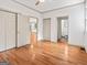 Bedroom with hardwood floors, multiple closets, and views to the bathroom at 187 Vanira Se Ave, Atlanta, GA 30315