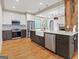 Modern kitchen with a large island, stainless appliances, and stylish countertops open to living room at 187 Vanira Se Ave, Atlanta, GA 30315