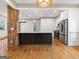Bright kitchen island with sink, stainless dishwasher, and custom cabinets in an open floorplan at 187 Vanira Se Ave, Atlanta, GA 30315