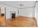 Spacious living room with gleaming hardwood floors and a stone fireplace, perfect for cozy evenings at 187 Vanira Se Ave, Atlanta, GA 30315