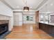 Bright living space boasts a stone fireplace, hardwood floors, and open layout to the kitchen at 187 Vanira Se Ave, Atlanta, GA 30315