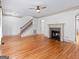 Expansive living area with hardwood floors, staircase, and a charming fireplace for a cozy ambiance at 187 Vanira Se Ave, Atlanta, GA 30315